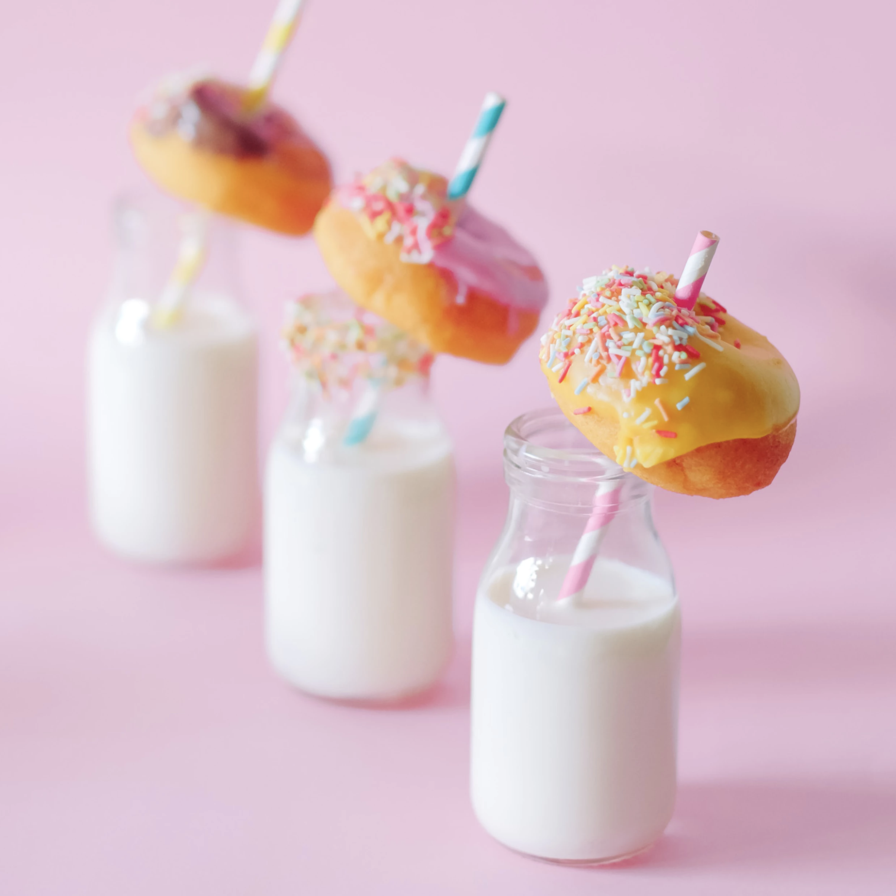 donuts, placed on milk bottles